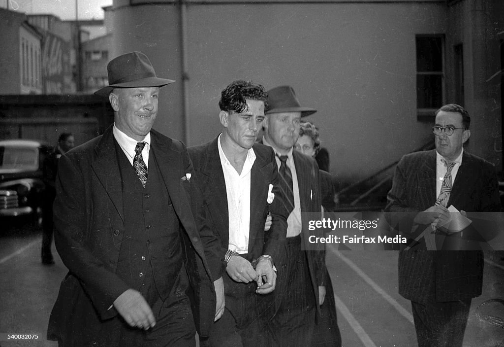 Darcy Dugan (centre) is arrested by Detective Raymond Kelly (right) and G.Goldin