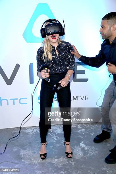 Actress Chloe Grace Moretz and NFL player Shawne Merriman check out the latest virtual reality and gaming technology at a VIP Alienware Party during...