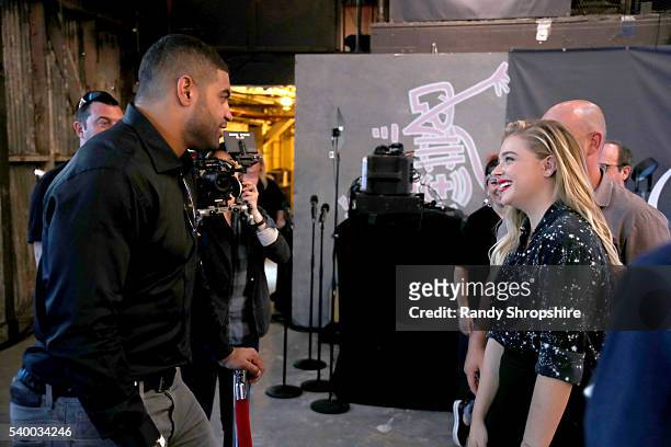Player Shawne Merriman and actress Chloe Grace Moretz check out the latest virtual reality and gaming technology at a VIP Alienware Party during E3,...