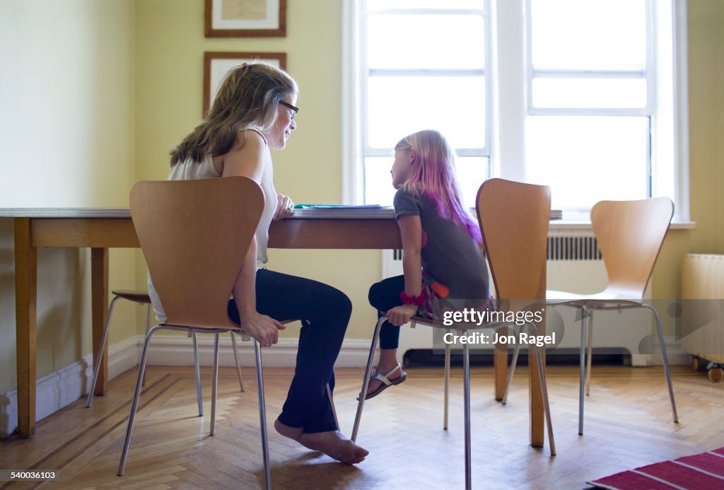 Mother helping daughter with homework