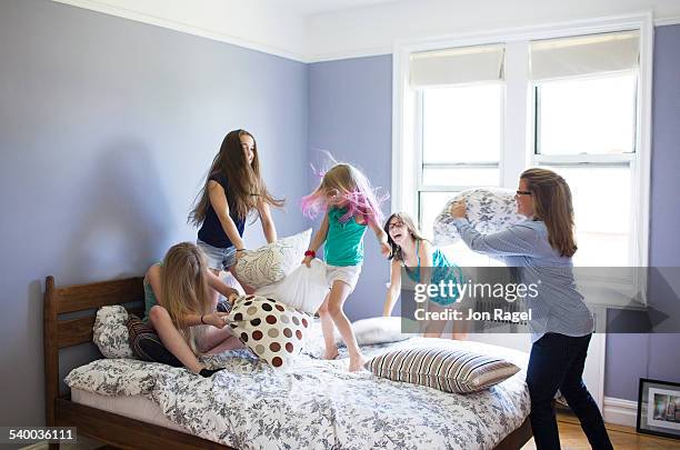 pillow fight with mother and 4 daughters - teenager man mischievous stock pictures, royalty-free photos & images