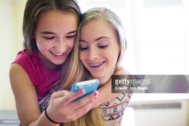 girls listening to music laughing. - solo bambine femmine foto e immagini stock