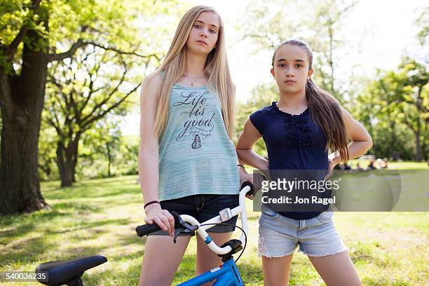 sisters in a park with bmx bike - 13 year old girls in shorts stock pictures, royalty-free photos & images