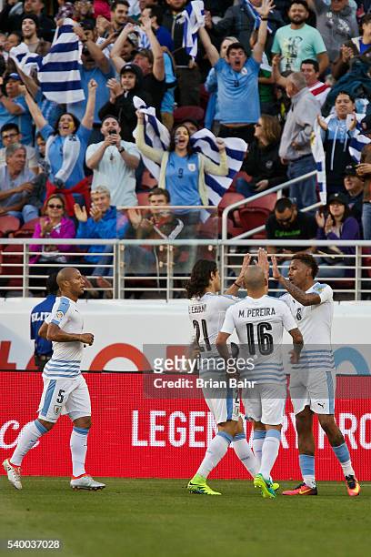 Abel Hernandez of Uruguay celebrates with teammates after scoring the opening goal during a group C match between Uruguay and Jamaica at Levi's...