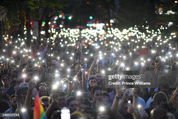 Attendees Hold Up Lights in Remembrance of those fallen in the Orlando Masscre on June 13, 2016 in New York City.