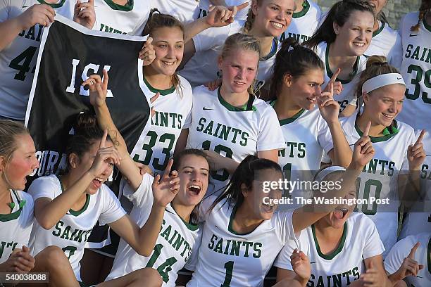 The St. Stephens & St. Agnes Saints celebrate with the championship banner May 16, 2016 in Bethesda, MD. The St. Stephens & St. Agnes Saints beat the...