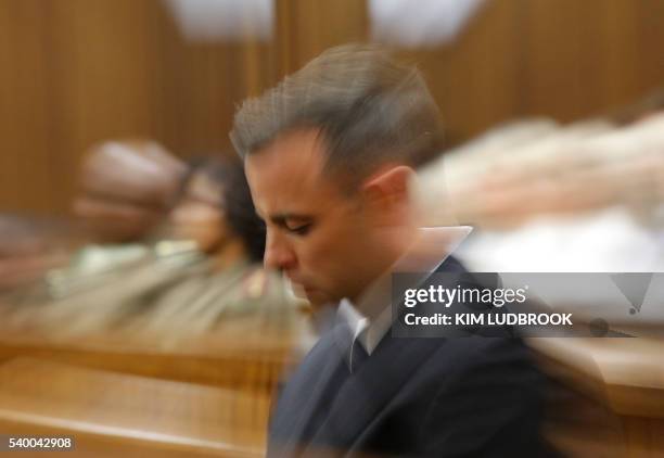 South African Paralympian Oscar Pistorius is pictured inside the dock at the high court in Pretoria, on June 14, 2016 on the second day of South...