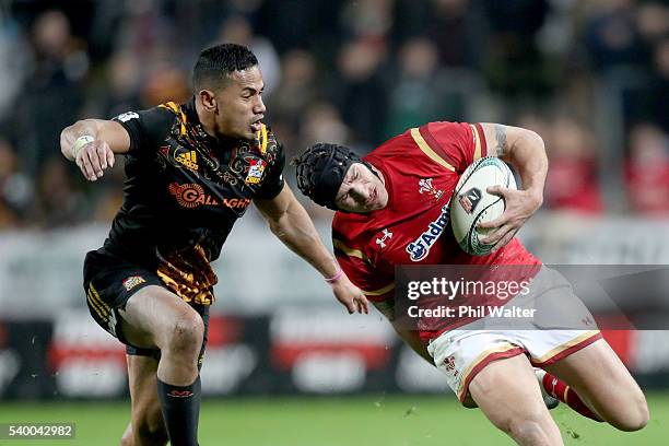 Tom James of Wales is tackled by Toni Pulu of the Chiefs during the International Test match between the Chiefs and Wales at Waikato Stadium on June...