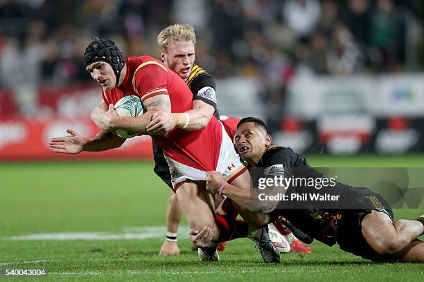 Tom James of Wales is tackled during the International Test match between the Chiefs and Wales at Waikato Stadium on June 14, 2016 in Hamilton, New...