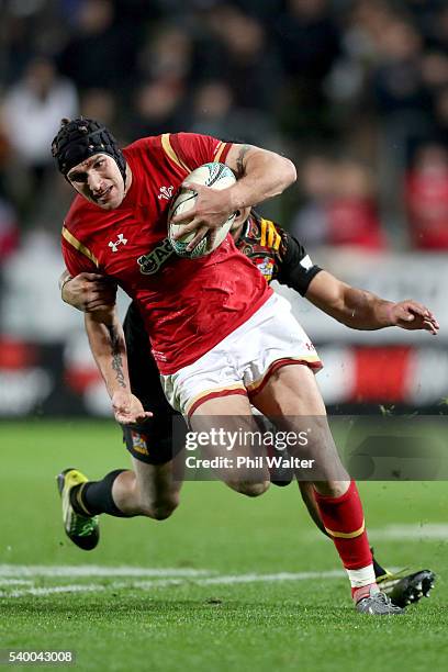 Tom James of Wales is tackled by Toni Pulu of the Chiefs during the International Test match between the Chiefs and Wales at Waikato Stadium on June...