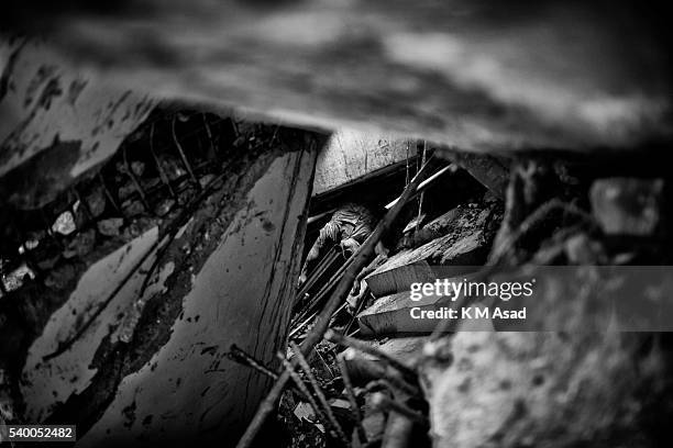 The body of a garment worker is trapped under the debris of the collapsed building at Savar, Dhaka Bangladesh, 03 May 2013. Reports state that 1130...