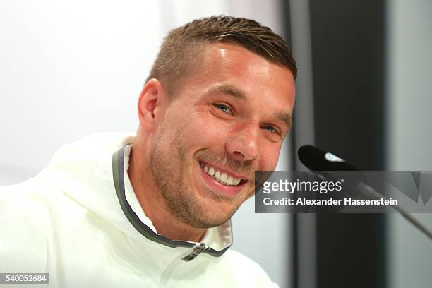 Lukas Podolski of Germany talks to the media during a Germany press conference ahead of the UEFA EURO 2016 at Ermitage Evian on June 14, 2016 in...