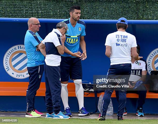 Head coach Italy Antonio Conte, Graziano Pelle and Doctor Enrico Castellacci chat during the training session at "Bernard Gasset" Training Center on...