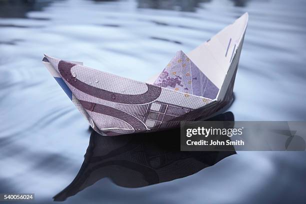 paper money boat - paper boat stock pictures, royalty-free photos & images