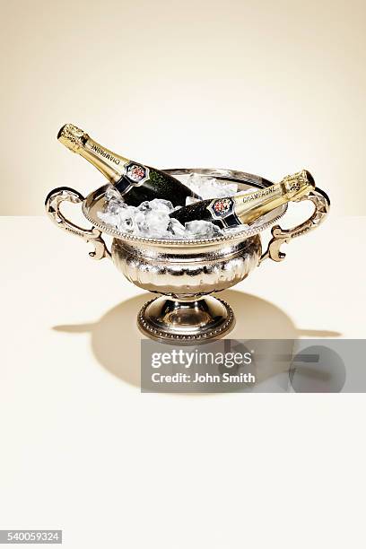 champagne bottles in ice bucket - champagne bucket stock pictures, royalty-free photos & images