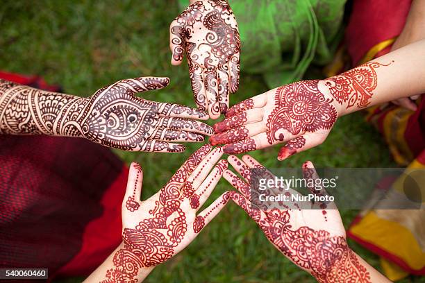 Bangladeshi girl shows her hand, decorated with henna during the Mehendi Festival a festival ahead of Ramadan in Dhaka, Bangladesh on June 11, 2016....
