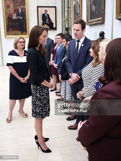 Catherine, Duchess of Cambridge meets staff after she signed a book of condolence for Orlando mass shooting victims at the US Embassy on June 14,...