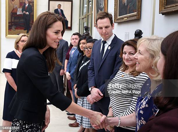 Catherine, Duchess of Cambridge meets staff after she signed a book of condolence for Orlando mass shooting victims at the US Embassy on June 14,...