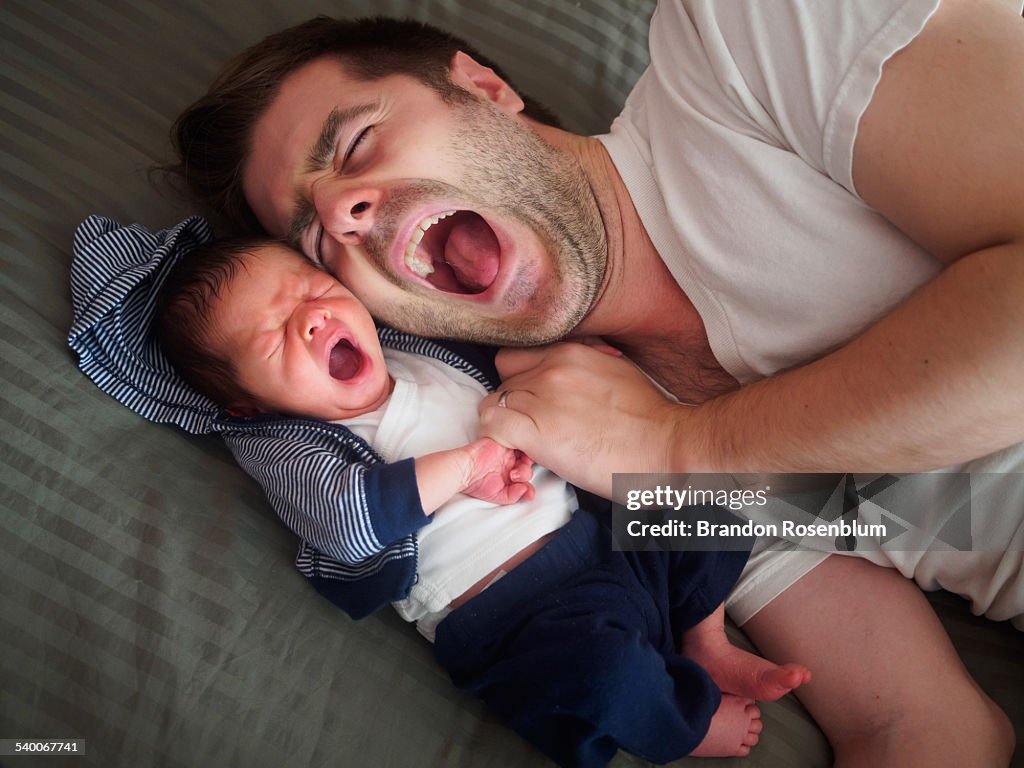 Father and son yawning