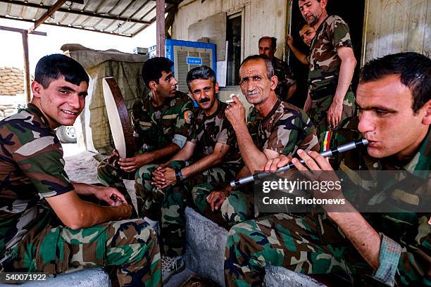 Daily life of the Iranian Kurds from PAK who have chosen to fight alongside Iraki Kurds against Daesh in Irak. Soldiers smoking and playing.