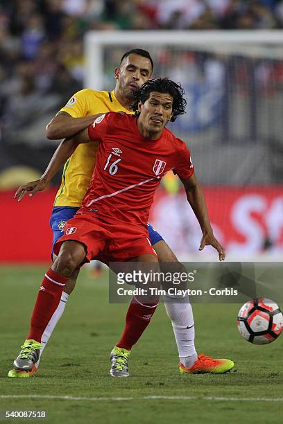 Oscar Vilchez of Peru holds off the challenge of Renato Augusto of Brazil during the Brazil Vs Peru Group B match of the Copa America Centenario USA...