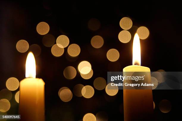 candles in front of an out of focus christmas tree - hatboro stock pictures, royalty-free photos & images