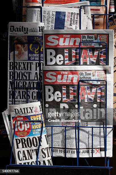 Copies of "The Sun" newspaper sit on a news stand in this arranged photograph in London, U.K., on Tuesday, June 14, 2016. The tabloid paper,...