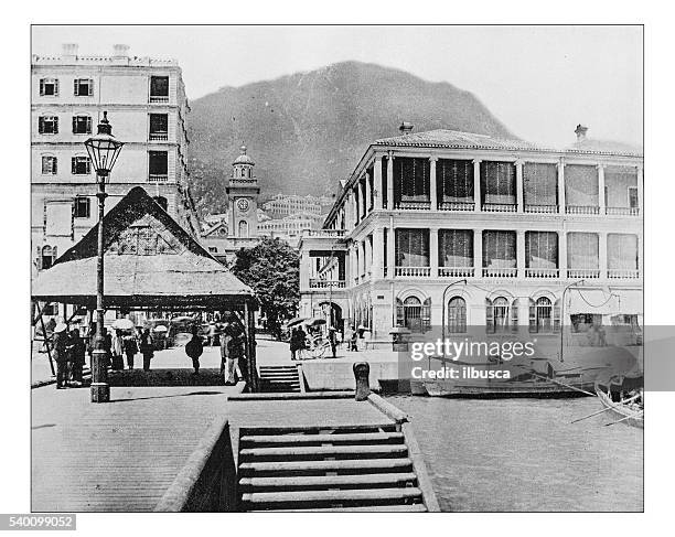 antique photograph of english buildings in hong kong (china)-19th century - tribal head gear in china stock illustrations