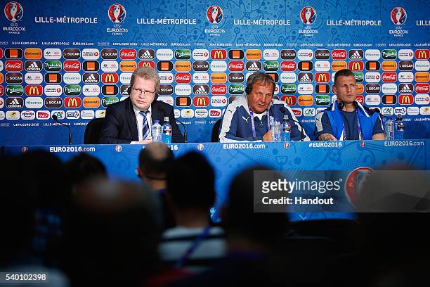 In this handout image provided by UEFA, Head Coach Jan Kozak of Slovakia talks to the media with Jan Durica during the Slovakia Press Conference at...