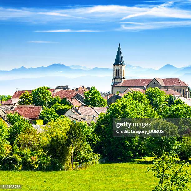 old french village in countryside with alps mountains in summer - steeple stock pictures, royalty-free photos & images