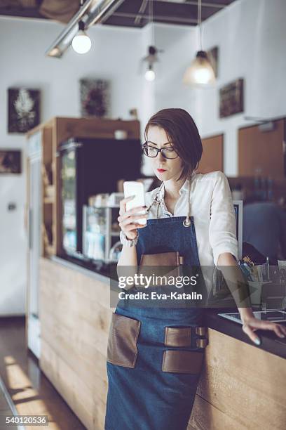 young barista is working in a café - hipster coffee shop candid stock pictures, royalty-free photos & images