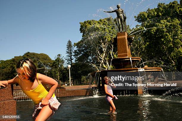 Pictured are Briana and Abby McKeogh enjoying the hot weather with a dip in Archibald Fountain at Hyde Park, 12 October 2006. SMH Picture by STEVEN...