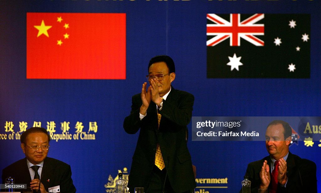 Mr. Wu Bangguo, Chairman of the China National People's Congress, stands in cent