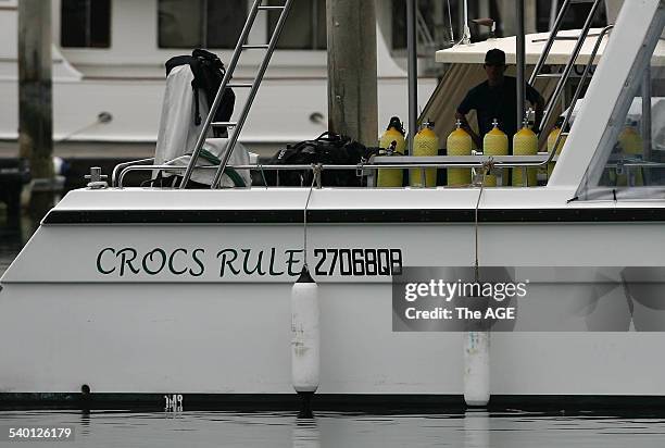 Deck hand cleans down Croc One, the boat Steve Irwin was diving from when he was killed by a Sting Ray near Batt Reef off the coast of Port Douglas...