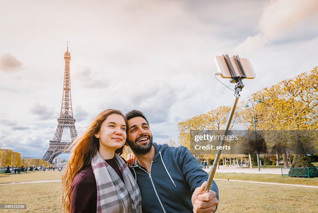 Young couple taking selfie with smartphone