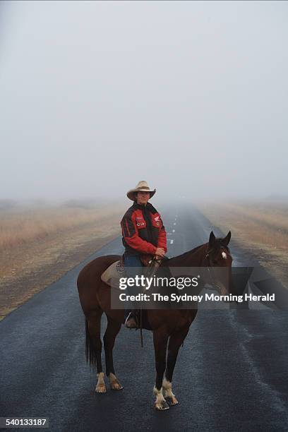 Janelle Little poses for a photo in the early morning fog on the Gwydir Highway, 40km from Moree, 11 October 2006. SMH Picture by ANDREW MEARES