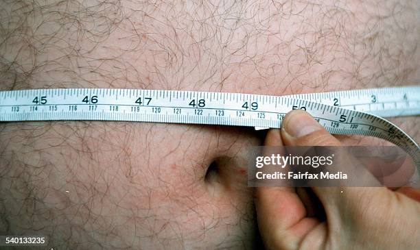 Tape measure is used to guage the girth of a man's stomach, 26 July 2001. AFR Picture by MICHELE MOSSOP