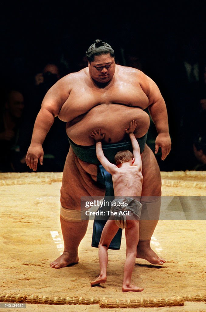 A young sumo fan pits his meagre proportions against the 275-kilogram ...