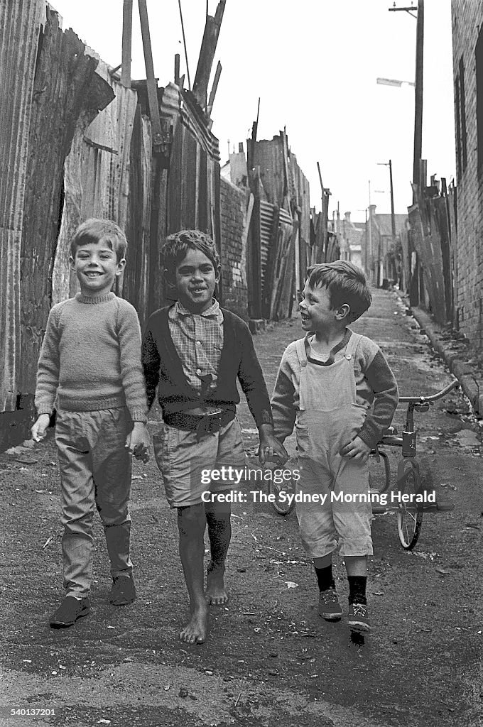 An Aboriginal boy, Victor Hookey, 5, centre, plays with his white friends, inclu