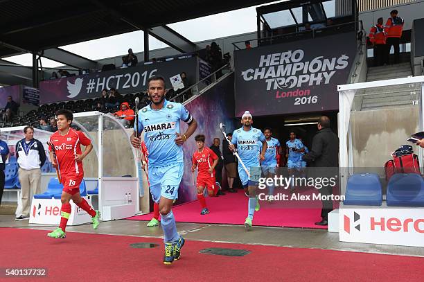 Sunil Sowmarpet of India and Hyosik You lead their teams out during the FIH Mens Hero Hockey Champions Trophy match between India and South Korea at...