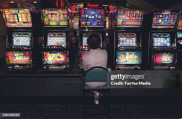 Gambler tries her luck at the poker machines, 10 April 1996. AFR Picture by PATRICK CUMMINS