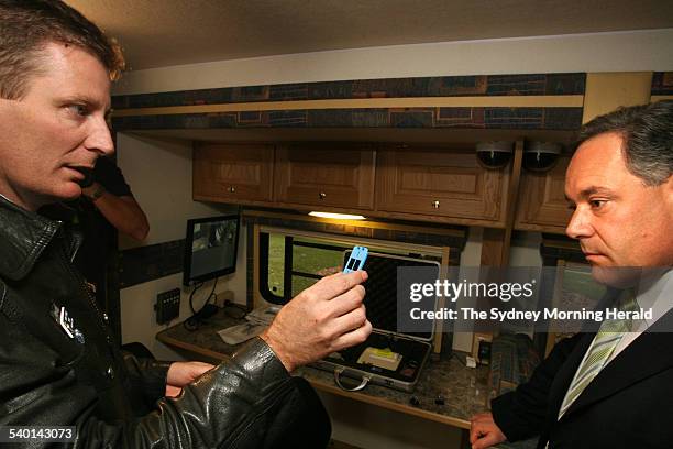 Mark Stevens from the police traffic technology section demonstrating the new random drug testing unit for the media outside state parliament, 31...