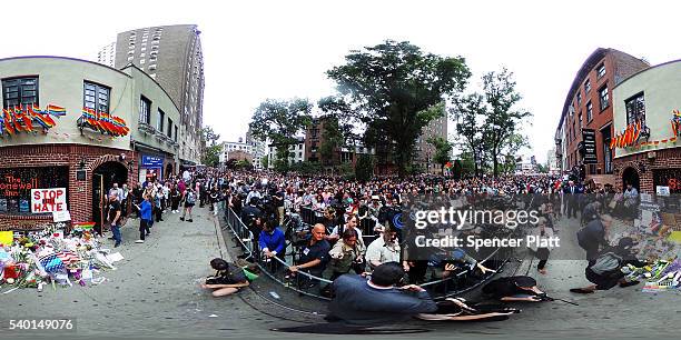 Hundreds of people listen to speakers at a memorial gathering for those killed in Orlando in front of the iconic New York City gay and lesbian bar...