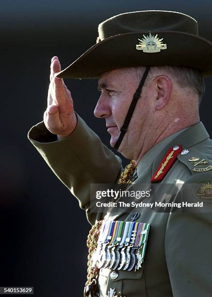 Admiral Chris Barrie hands over command of the Defence Forces to General Peter Cosgrove, pictured, who salutes him, at the change of command ceremony...