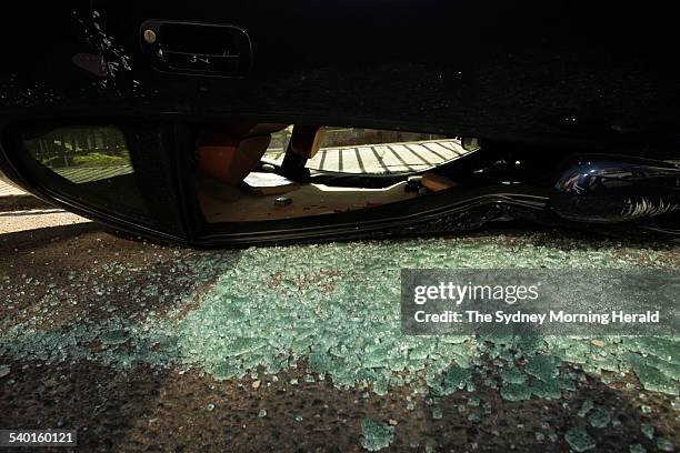 Glass lies on the street from an upturned $110,000 1999 3200 GT Maserati which fell from a forklift in Elizabeth Bay, Sydney. The car was parked in a...