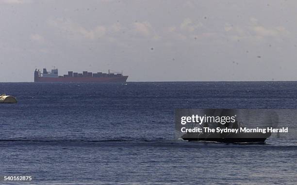 Australian SAS troops in an inflatable boat in Flying Fish Bay off the coast of Christmas Island, with the Norwegian freighter MV Tampa, laden with...