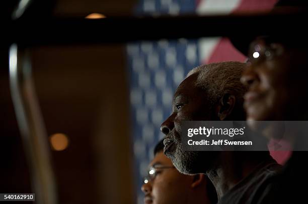 Attendees listen as presumptive Democratic nominee for president Hillary Clinton speaks at the International Brotherhood of Electric Workers Hall on...