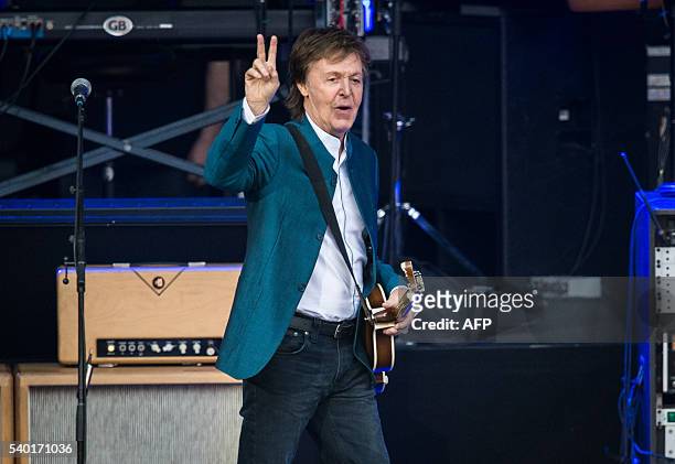 Ex-Beatle Paul McCartney gestures on stage during his "One on one" tour at the Waldbuehne in Berlin on June 14 / AFP / dpa / Sophia Kembowski /...