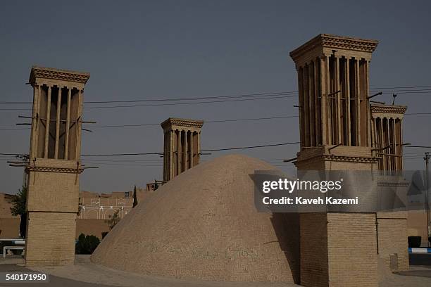 An old water reservoir with surrounding windcatchers seen in the old Zoroastrian neighborhood on September 2, 2015 in Yazd, Iran. A wind catcher is a...