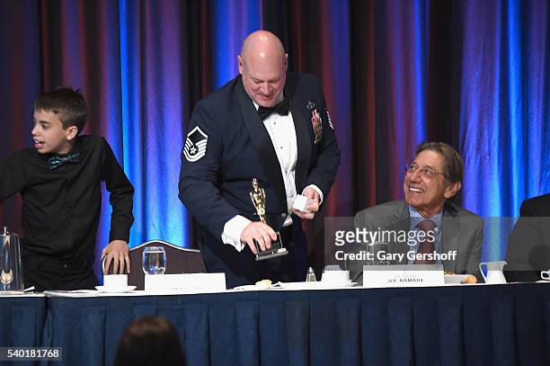 Event honorees Christopher A. Irving and Joe Namath seen on stage during the 75th Annual Father Of The Year Awards Luncheon at The New York Marriott...